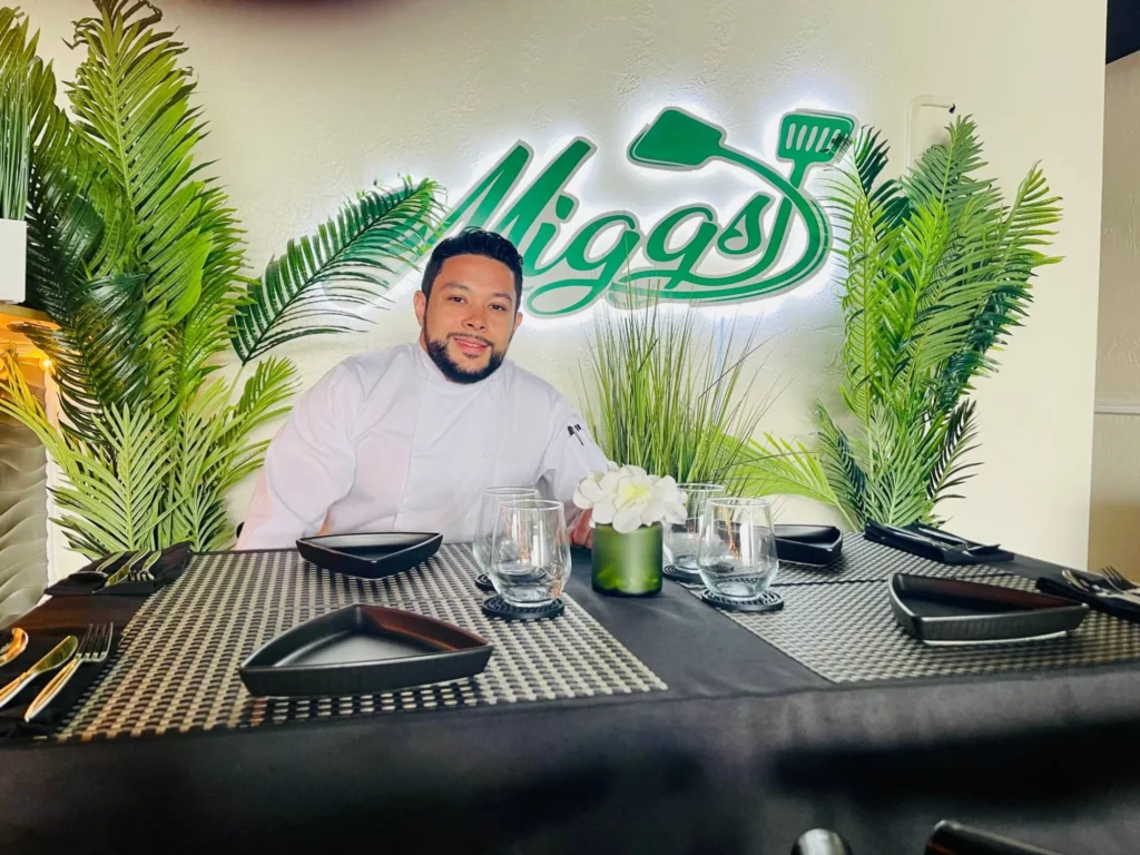 Chef Miguel Rosado at a table in the Miggs dining room