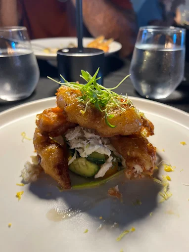 Crispy seafood stacked over avocado and lump crab