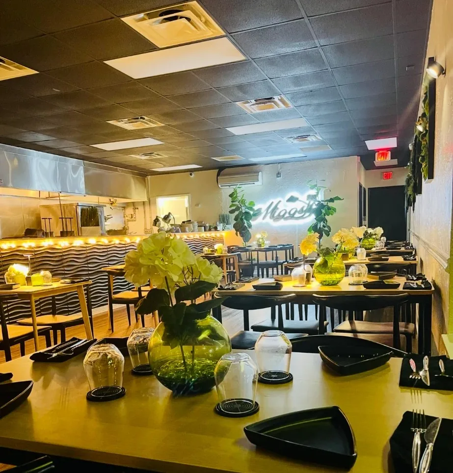The Miggs dining room and open kitchen, set for dinner