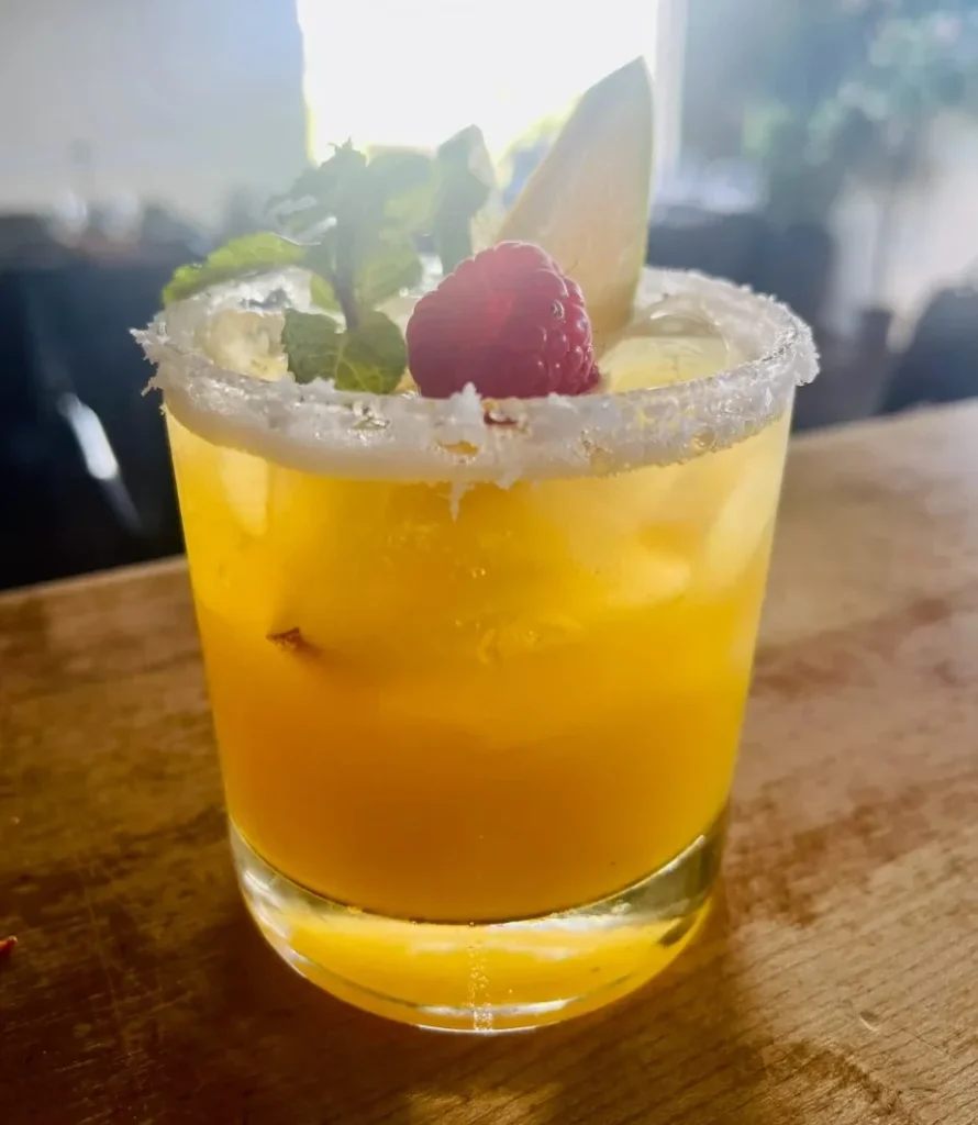 A mango wine-based margarita with raspberry and mint