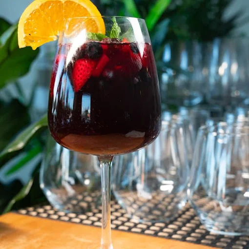 Red sangria with berries and an orange slice